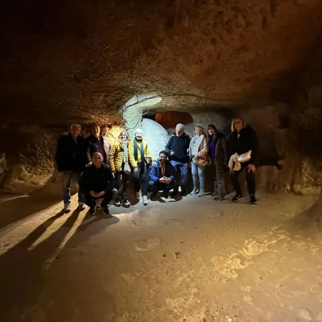 A tour group inside an underground city in Cappadocia