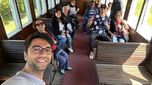 A group aboard a vintage train carriage