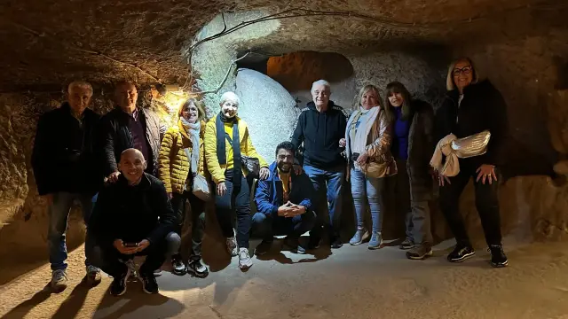 By the round stone door of an underground city in Cappadocia